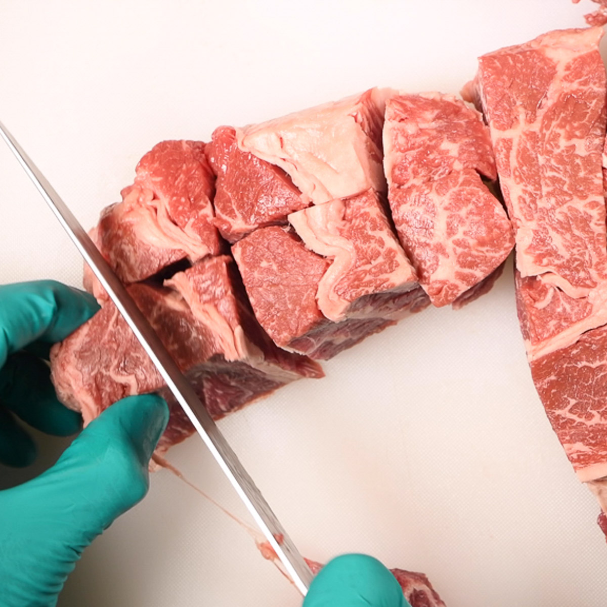 Chuck roast cut into pieces.