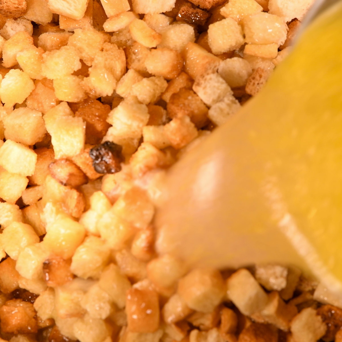 Pour butter mixture over the cubed bread.