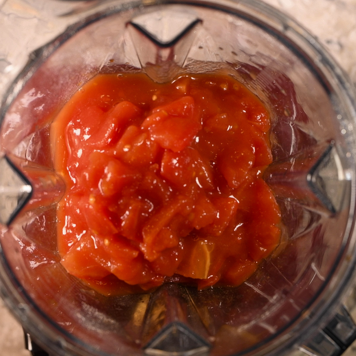 Add the canned tomatoes to the blender.