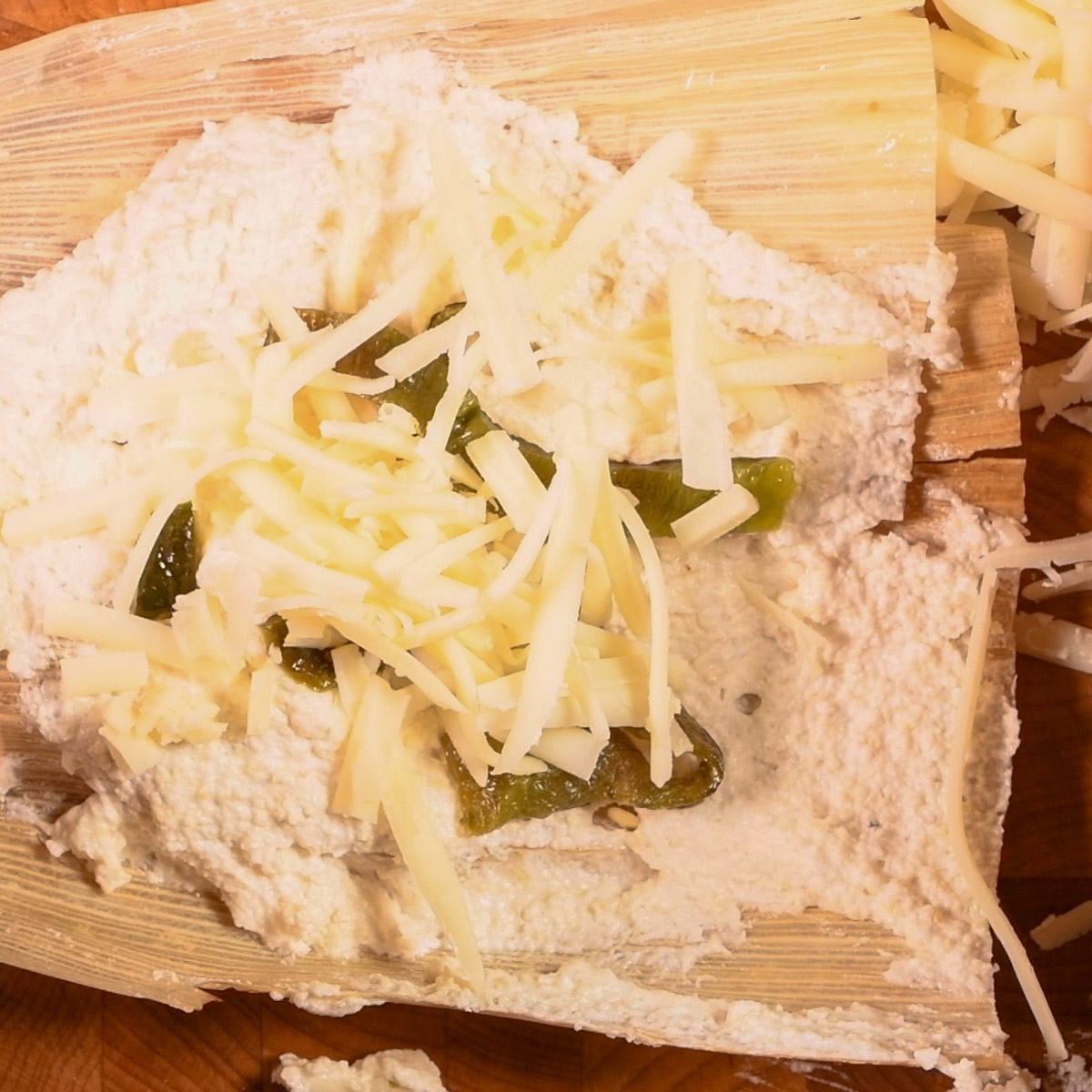 Add cheese on top of the poblano pepper strips.