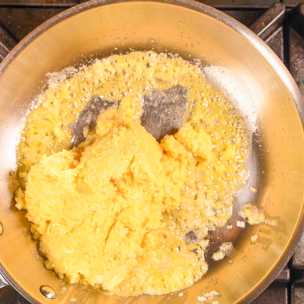 Add corn to shallots and butter.