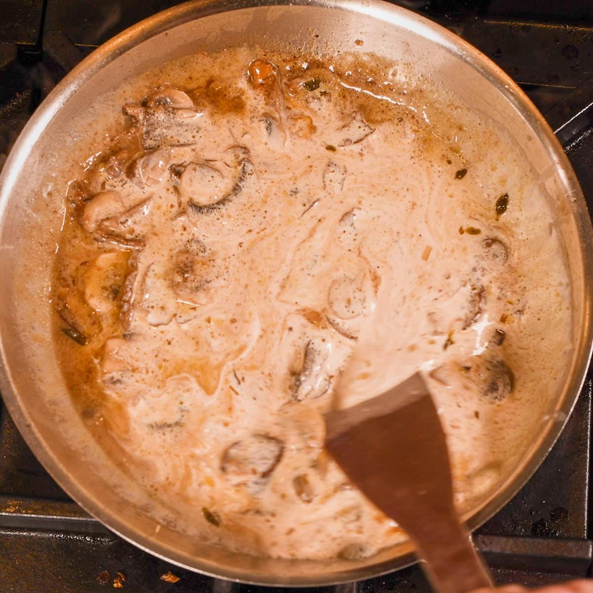 Add heavy cream to the shallots and mushrooms.