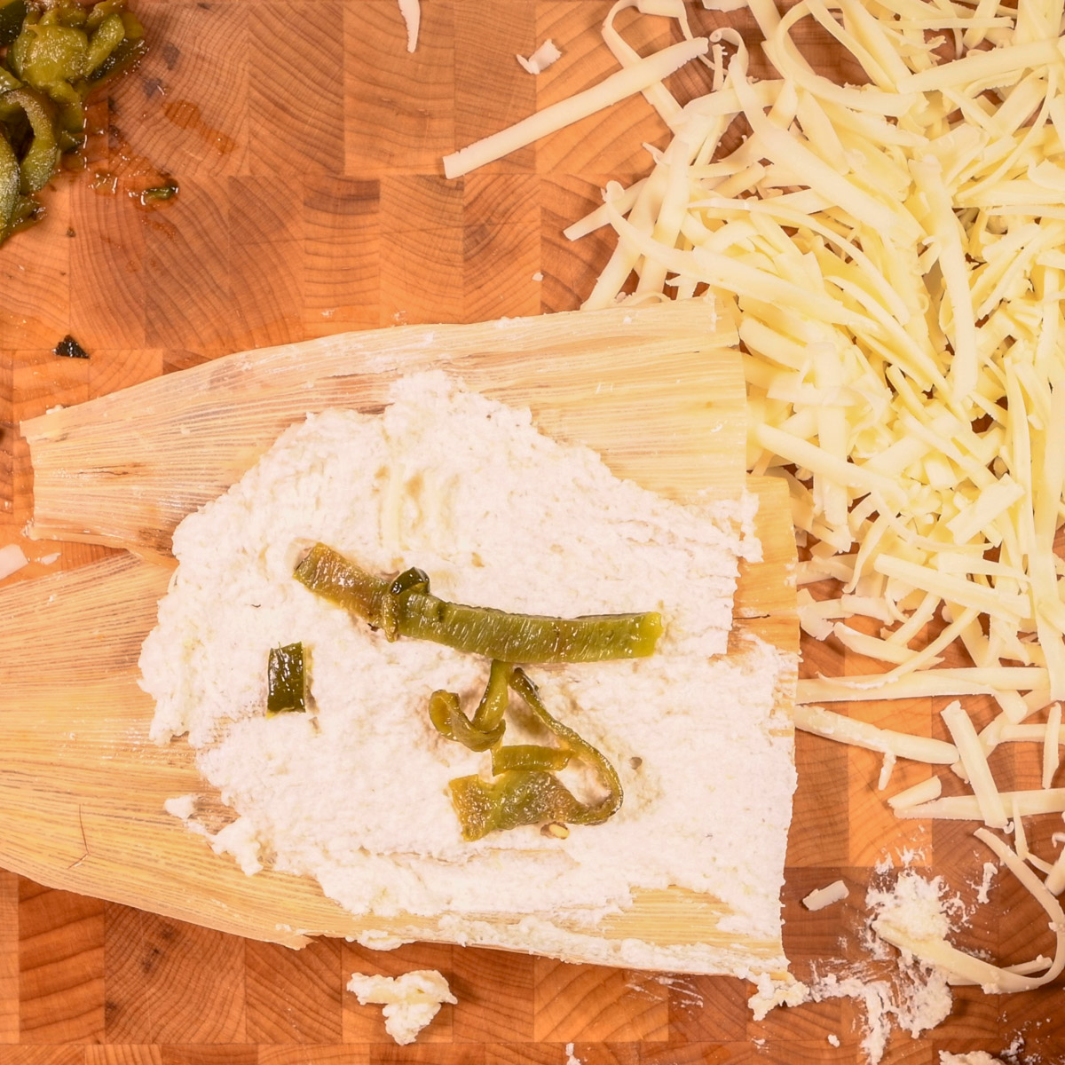 Add poblano pepper strips on top of the masa.