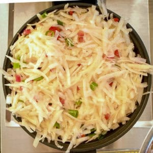 Add the hash browns to the hot waffle iron.