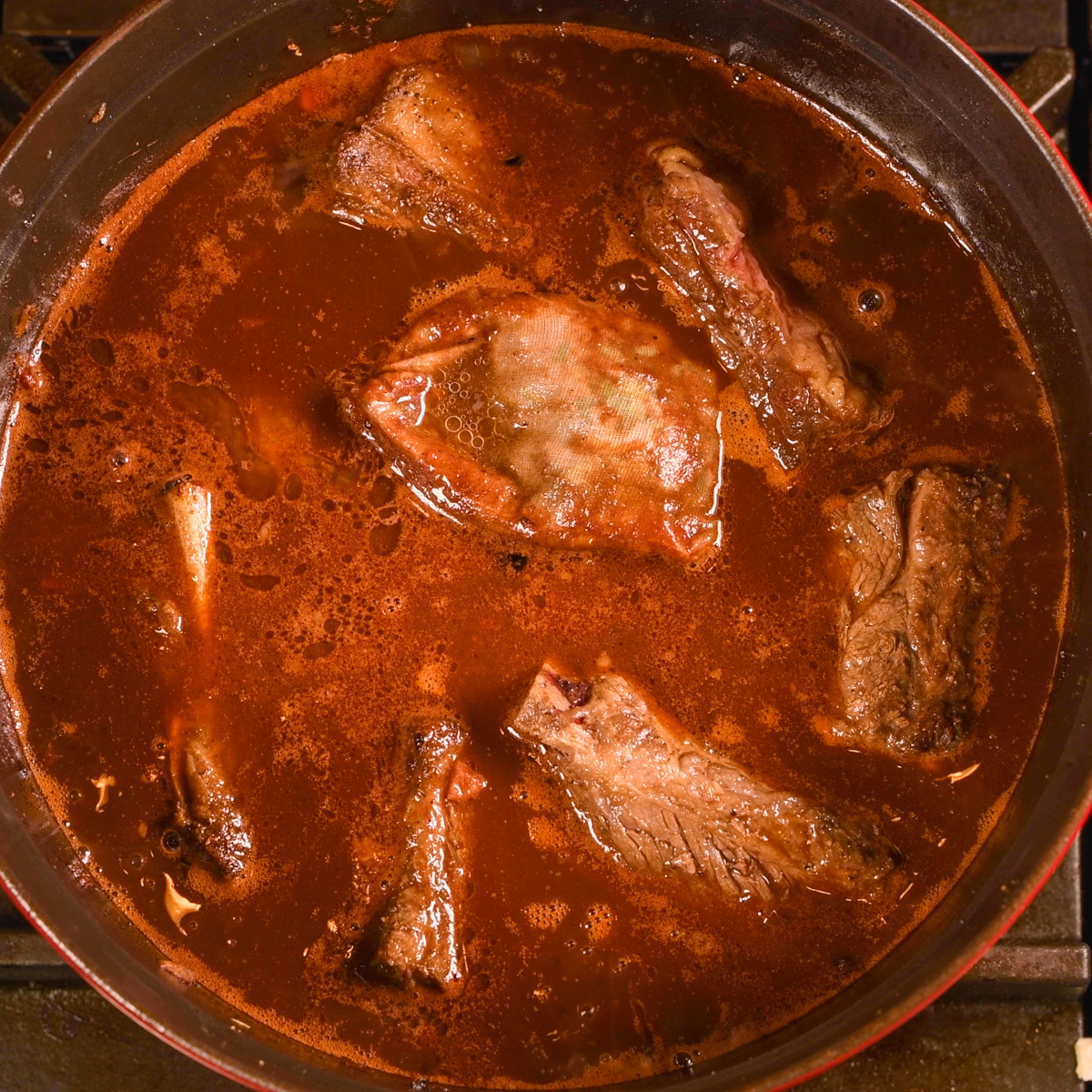 Add the seared short ribs to the Dutch oven.
