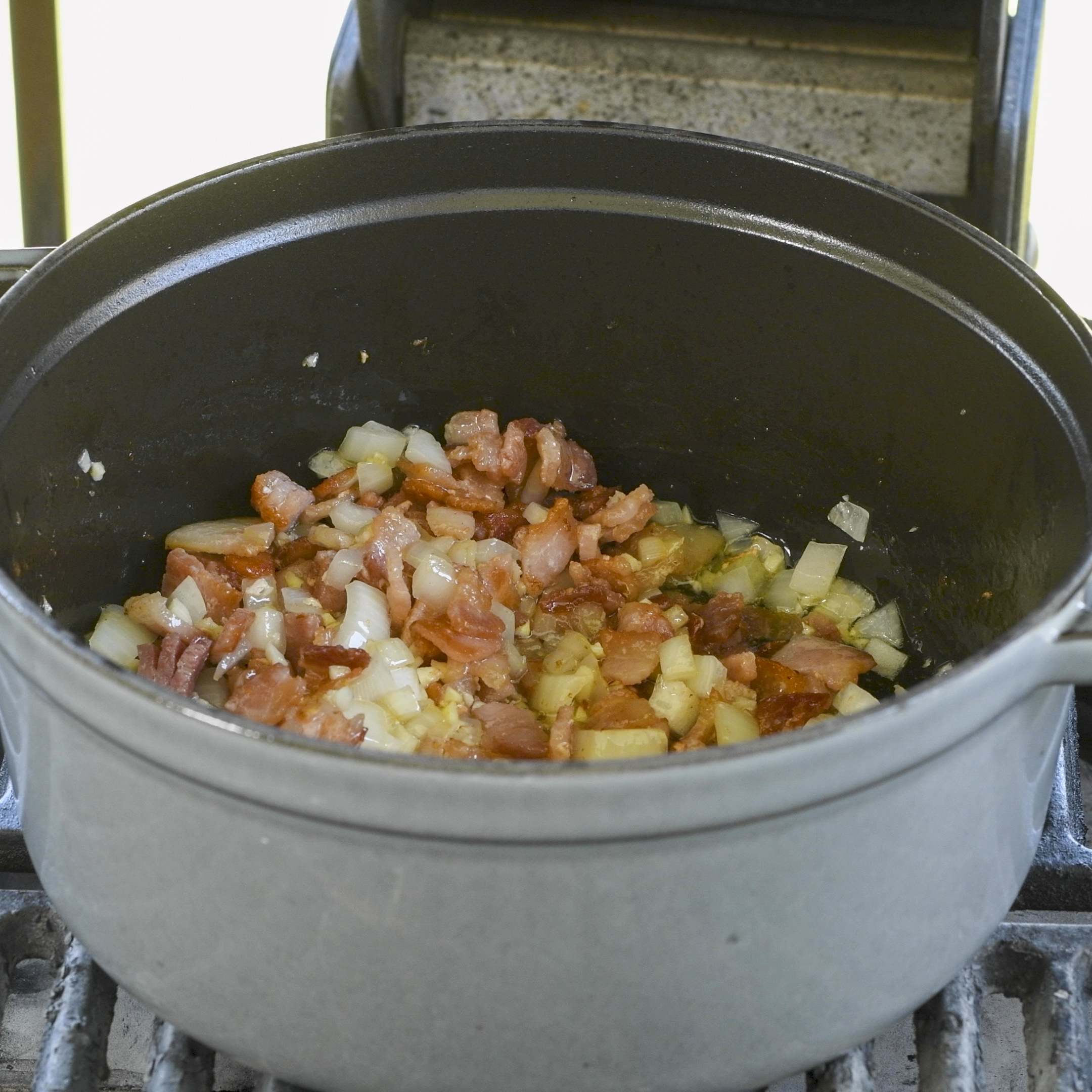 Bacon and onion in the Dutch oven.