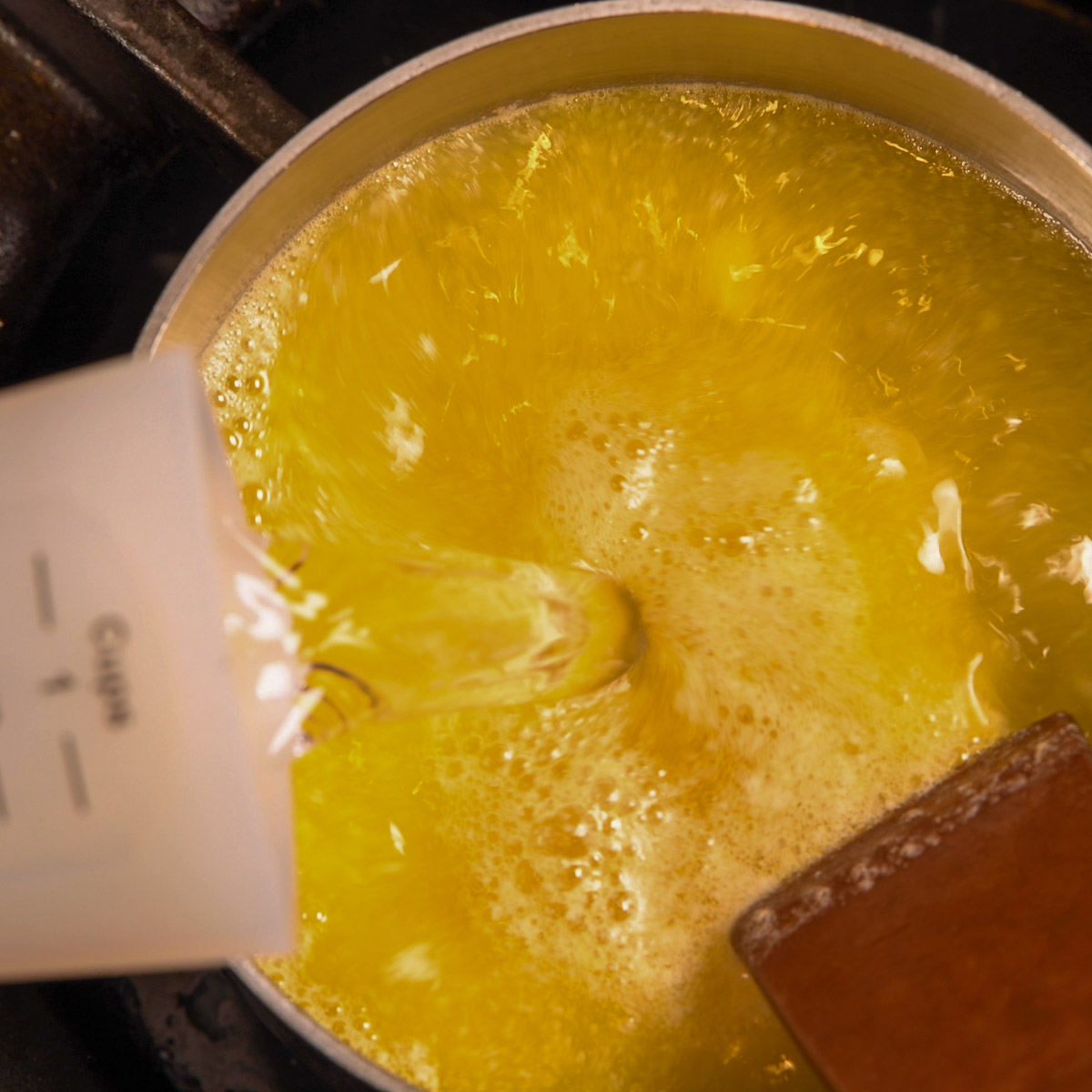 Add water and chicken stock to the melted butter.