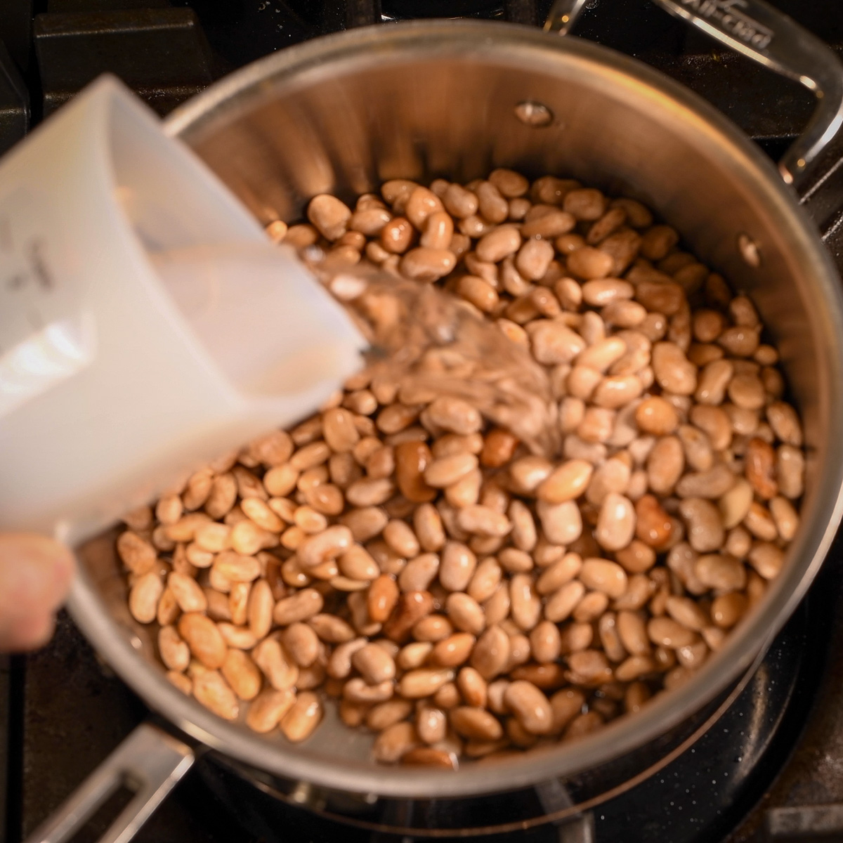 Add water to soaked beans.