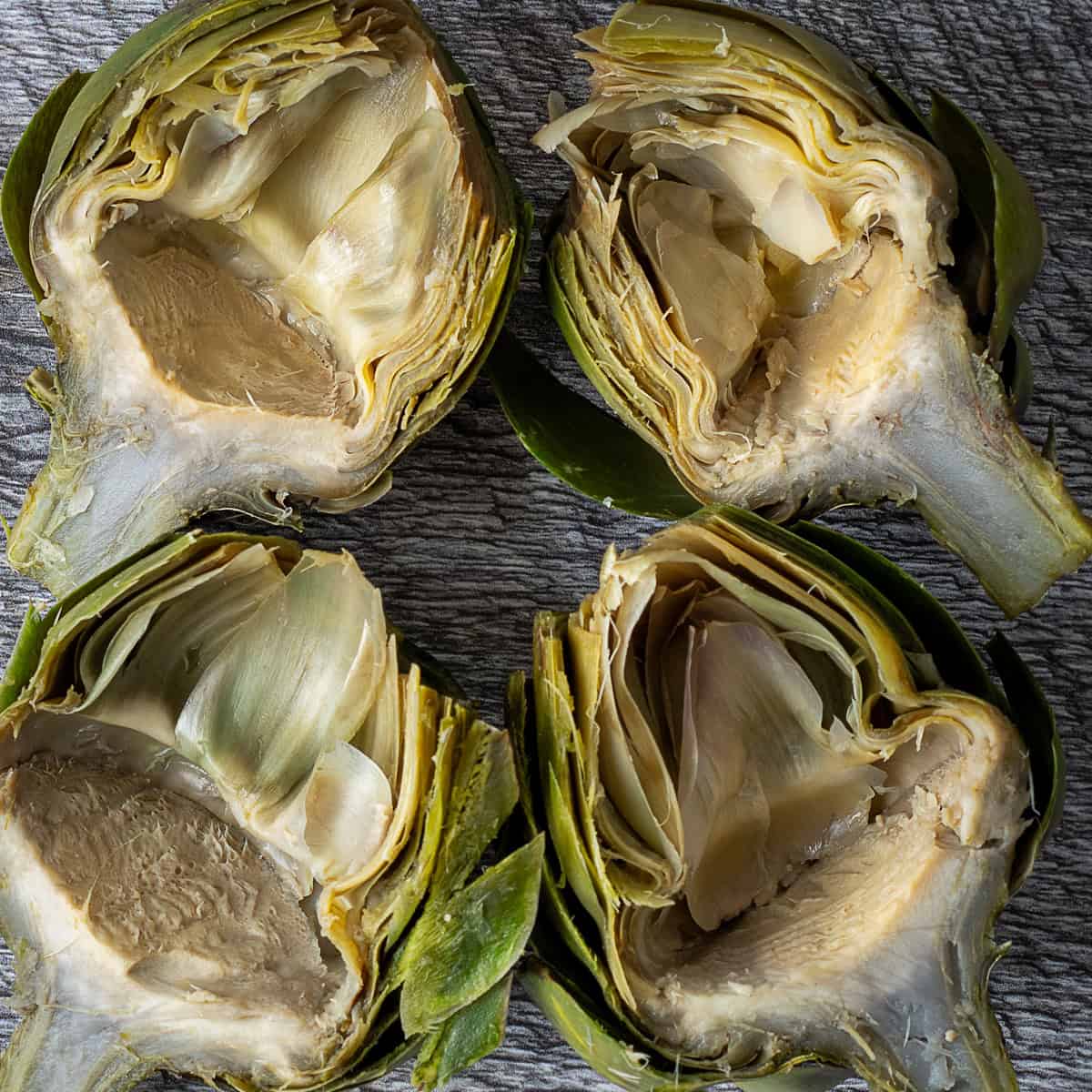 Cooked artichokes cut in half, chokes removed.