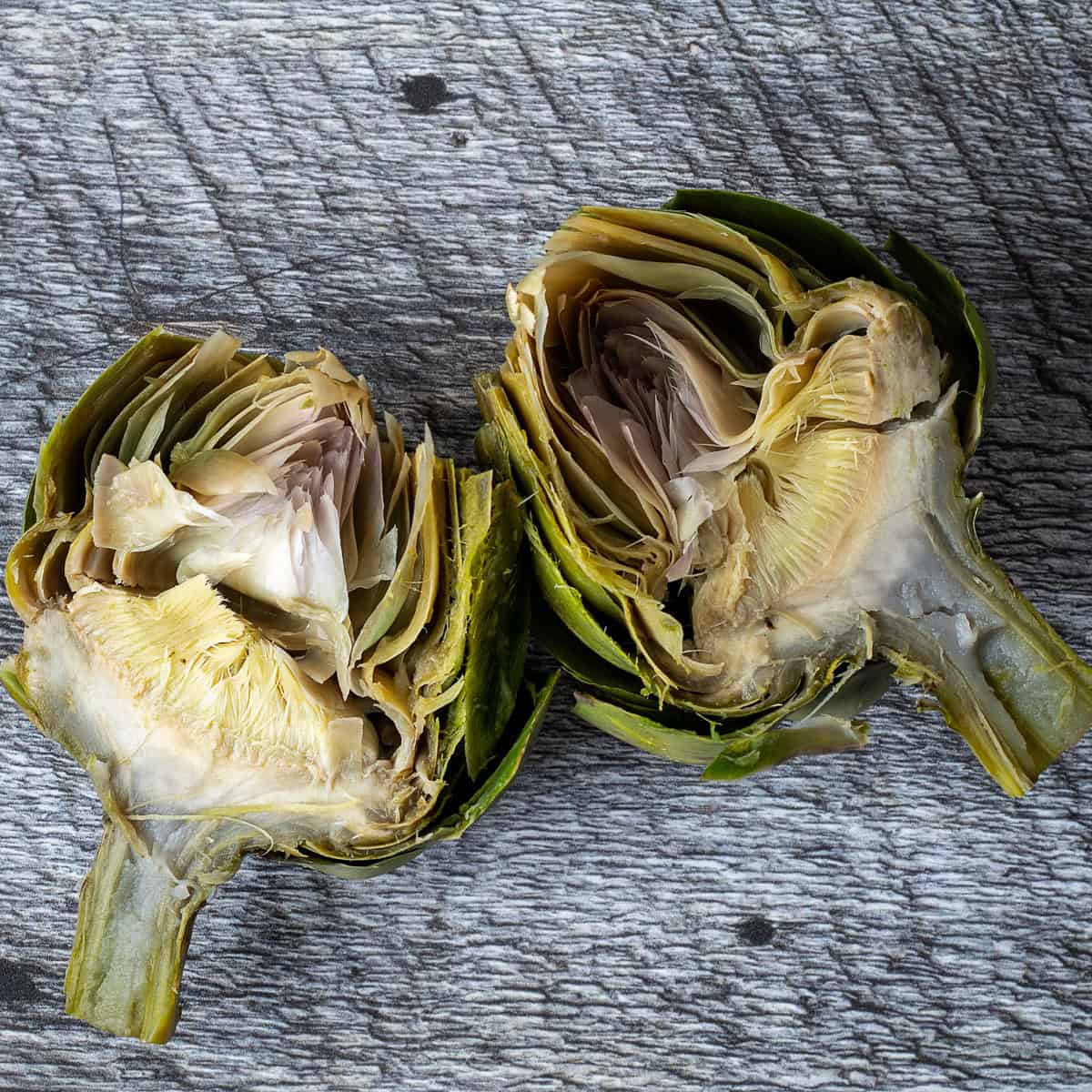Cooked artichokes cut in half.