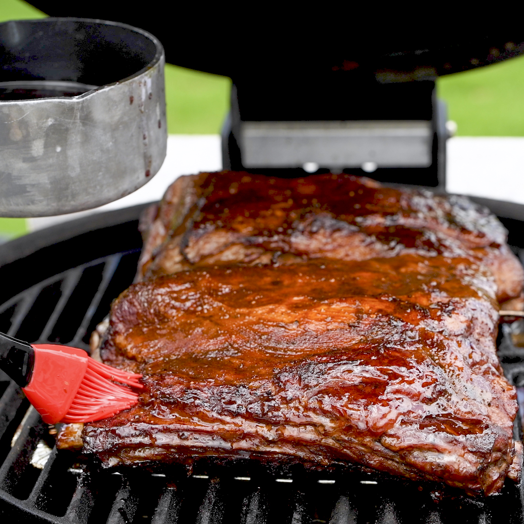 Beef ribs over a water pan inside a Kamado Joe.
