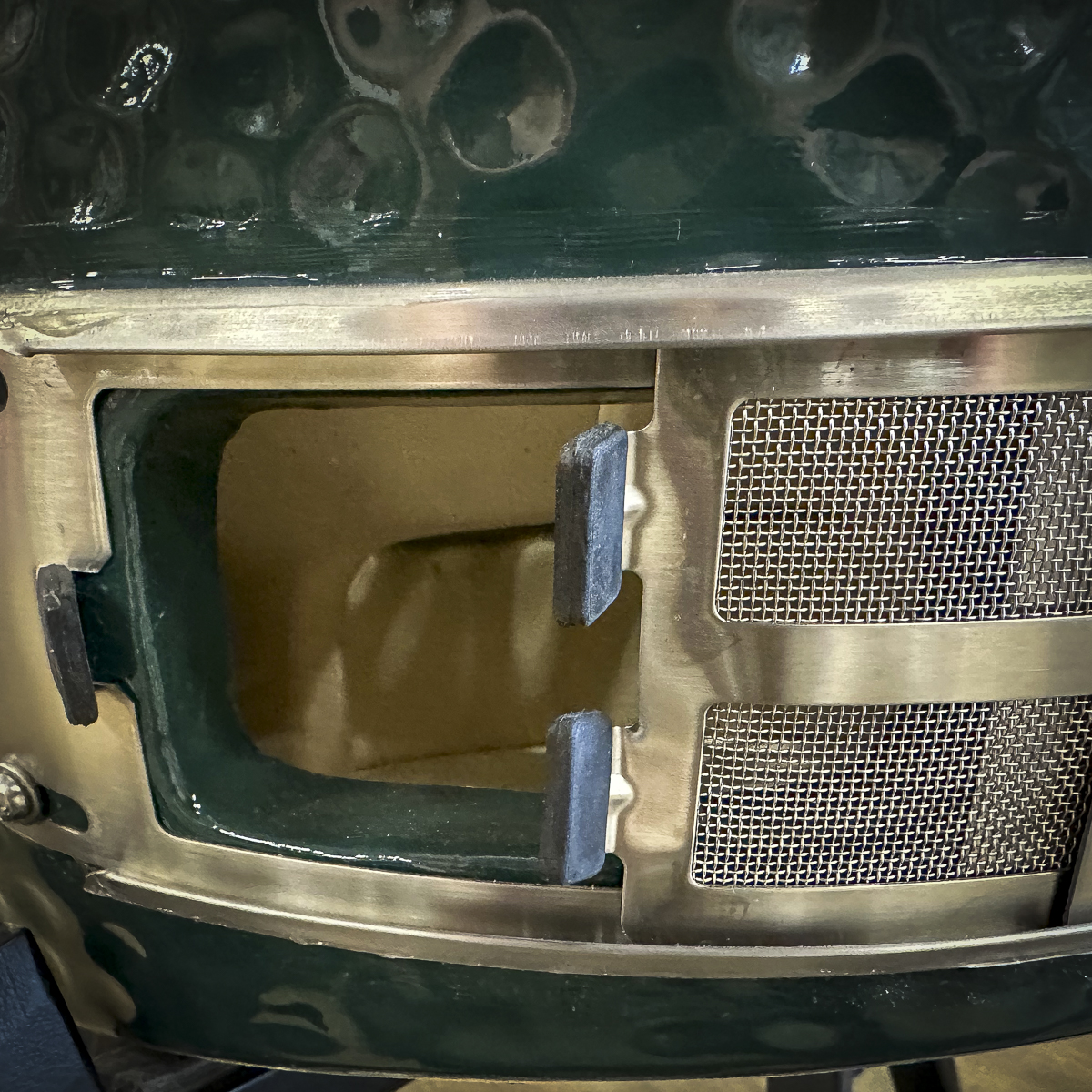 Ash is removed through the bottom vent on a Big Green Egg.