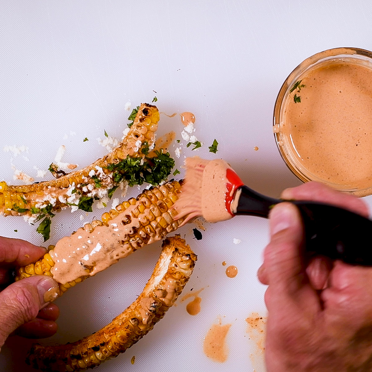 Brush the cooked corn ribs with sauce.