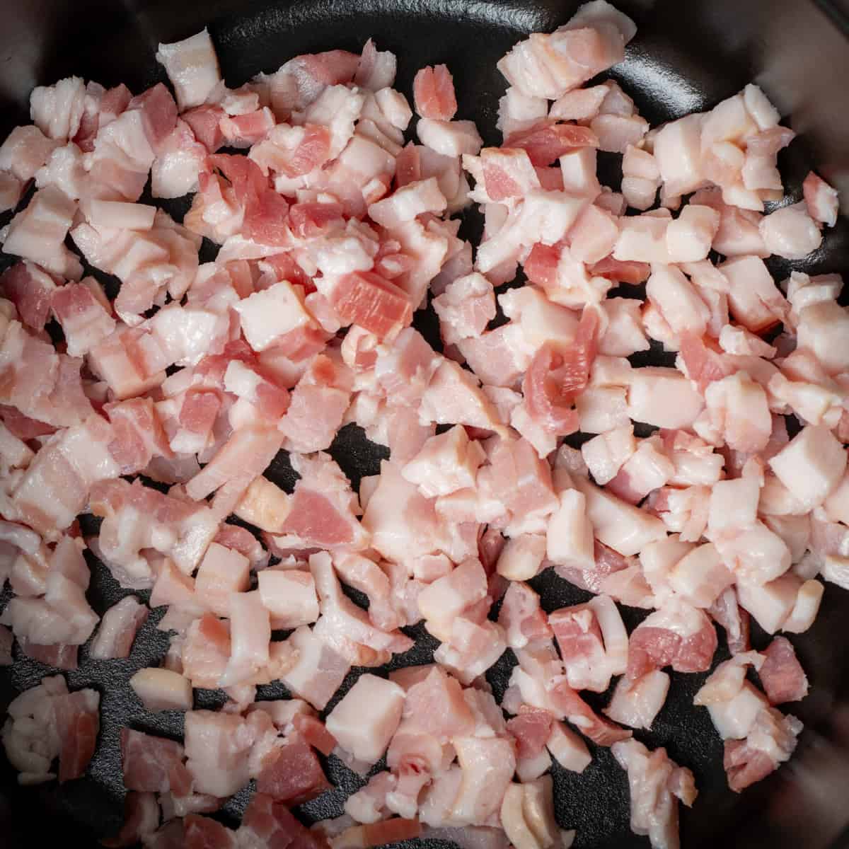Cook chopped bacon in a Dutch oven.