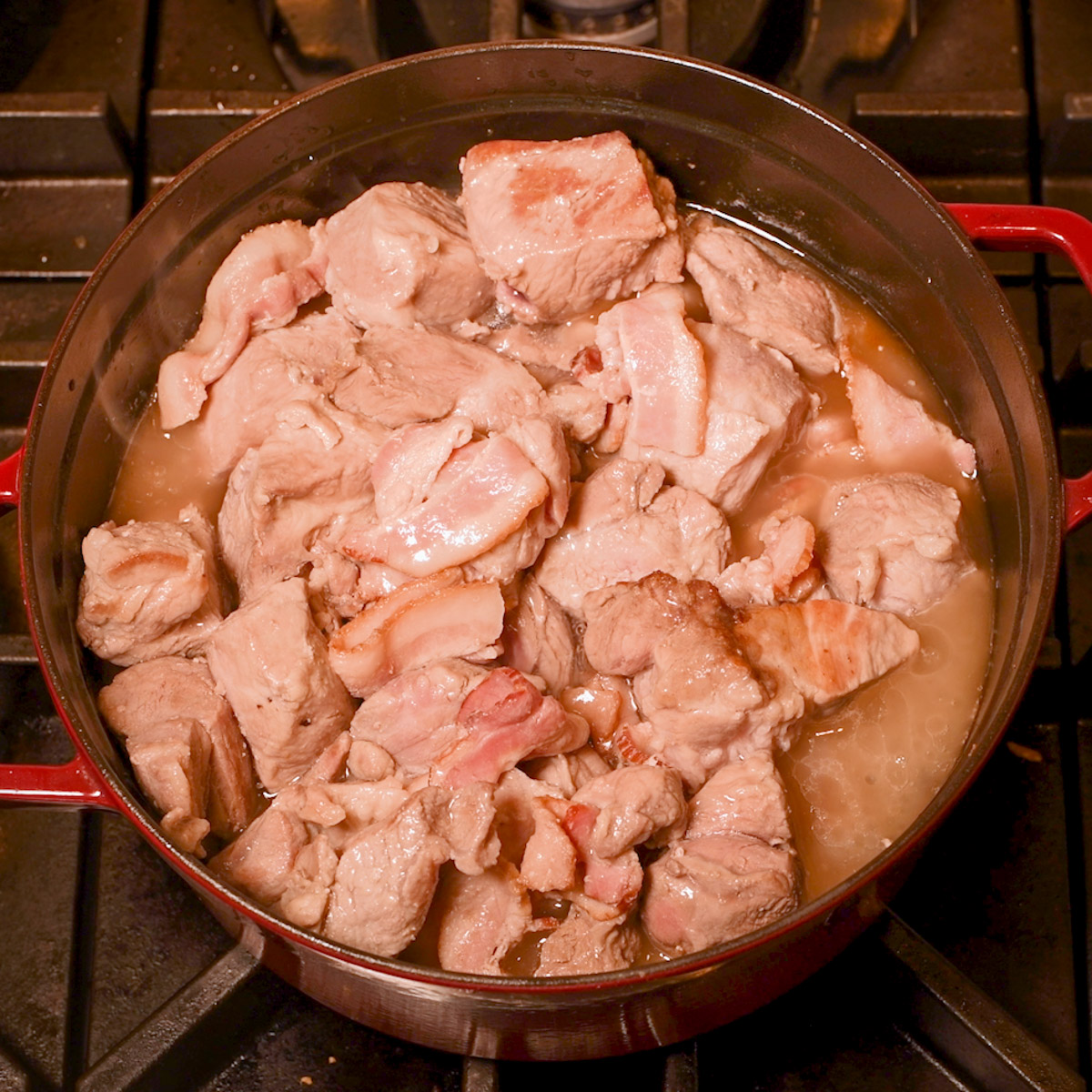 Cook the pork shoulder pieces together with the bacon.