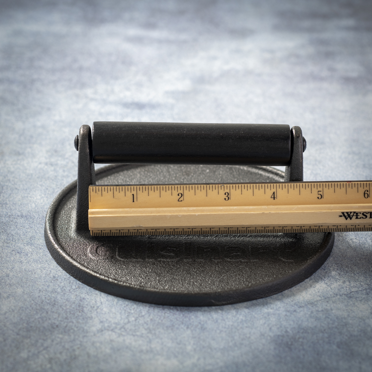 The Cuisinart cast-iron burger press has 4.25 inches internal handle clearance.