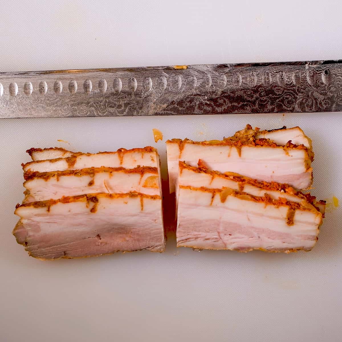 Cut the strips of pork belly in half.