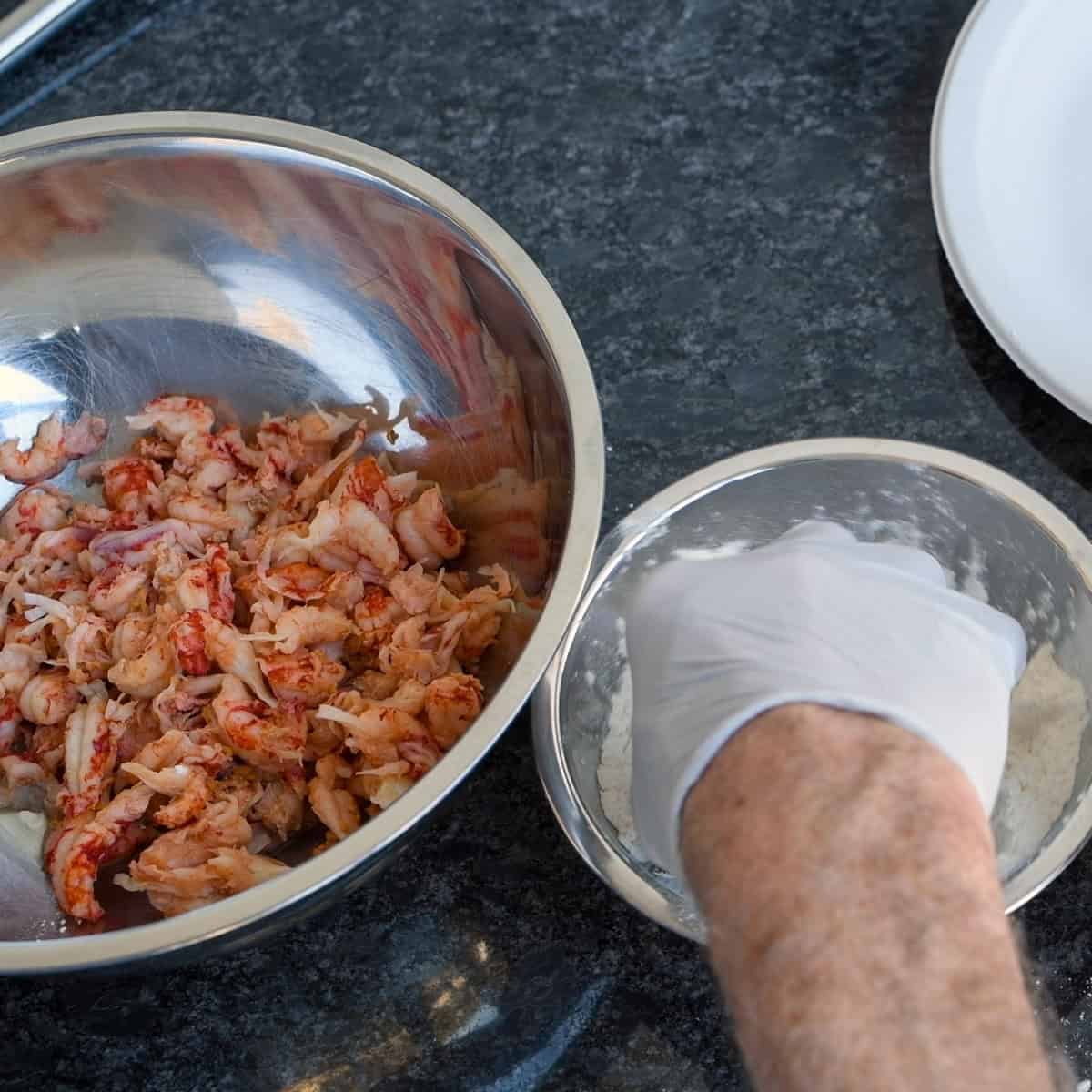 Dredge the crawfish in dry tempura batter.