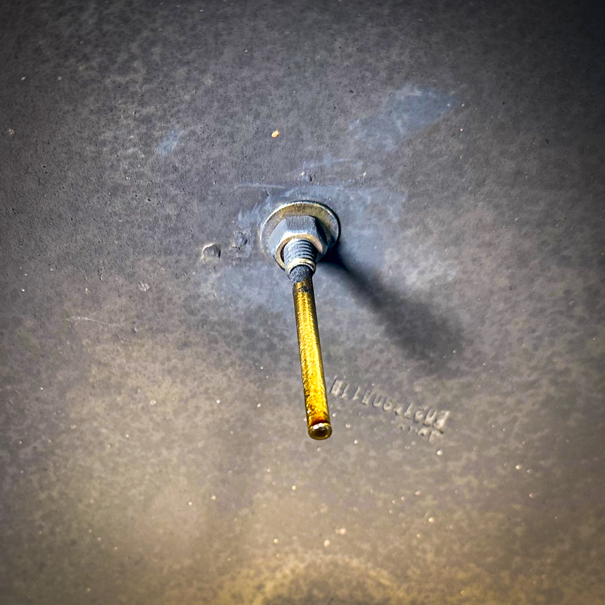 The dome thermometer stem seen from inside the Kamado Joe lid.