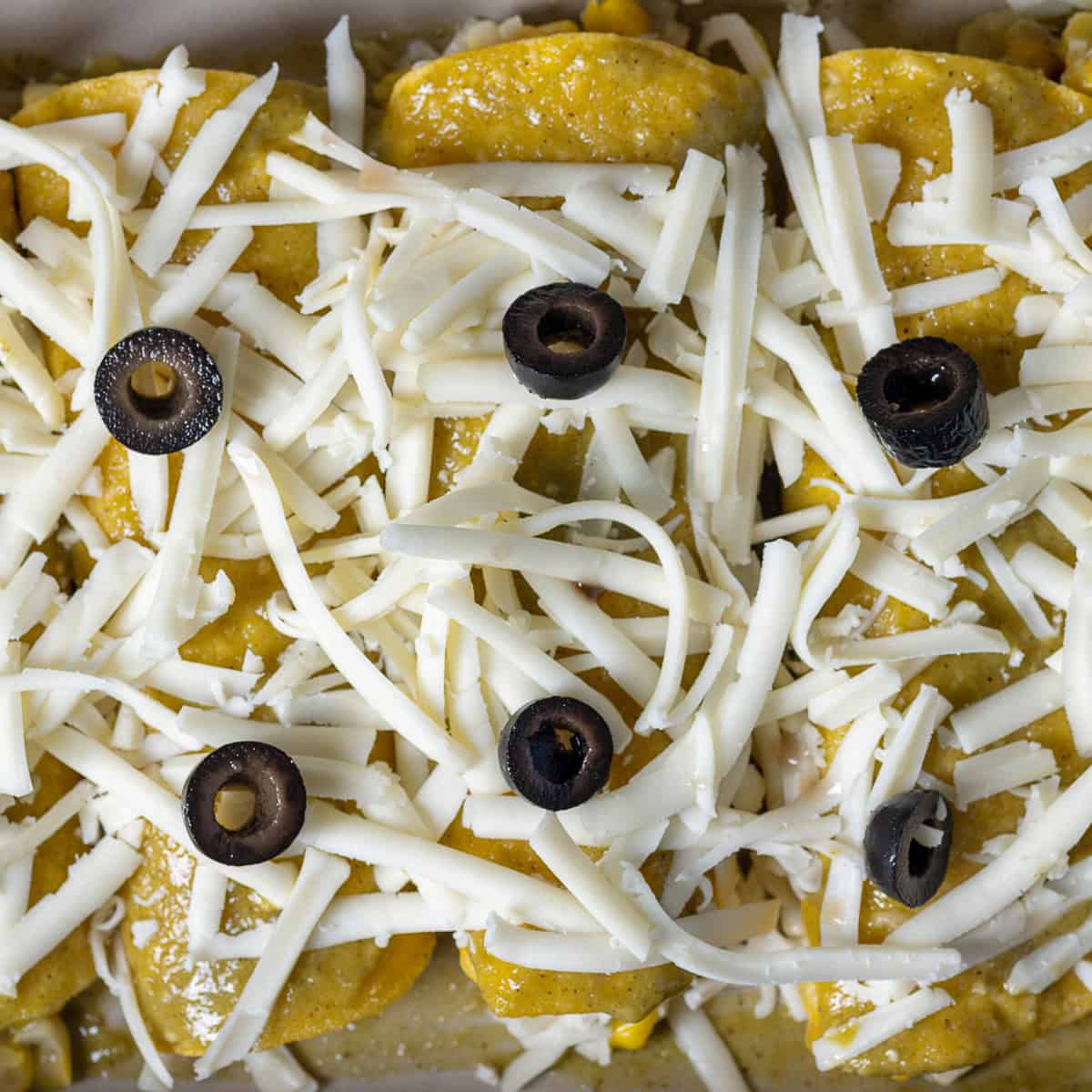 Enchiladas seam side down in a casserole dish.