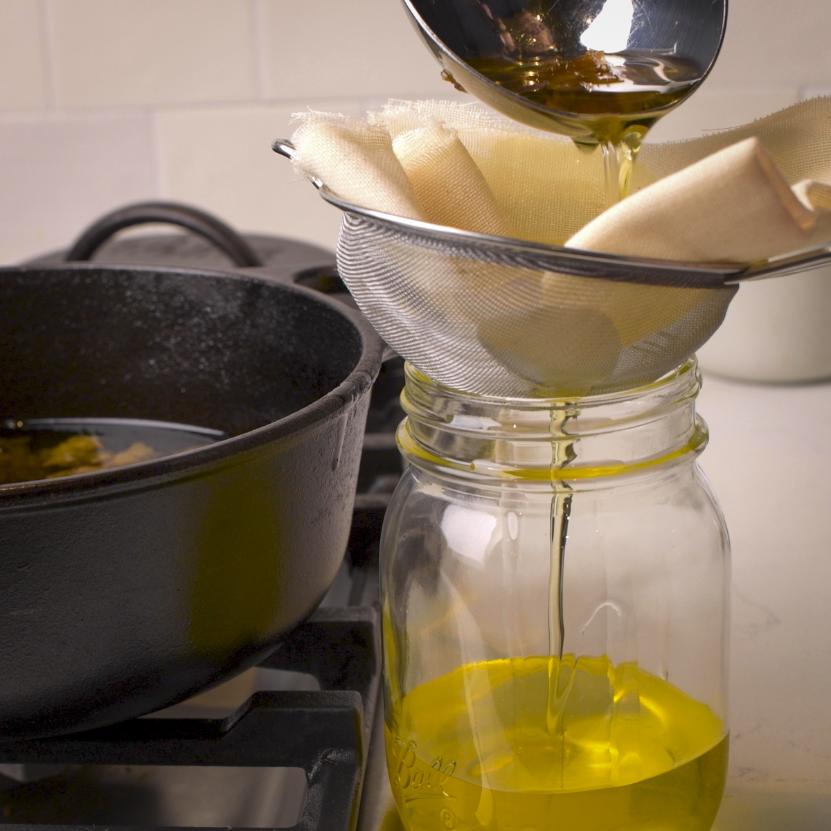 Filter rendered beef tallow through a cheesecloth-lined strainer.