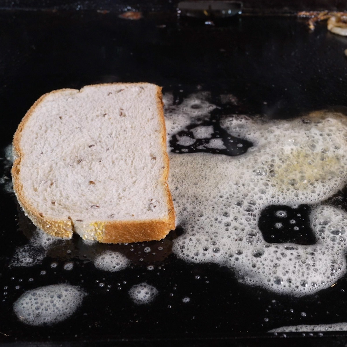 Grill rye bread in melted butter.