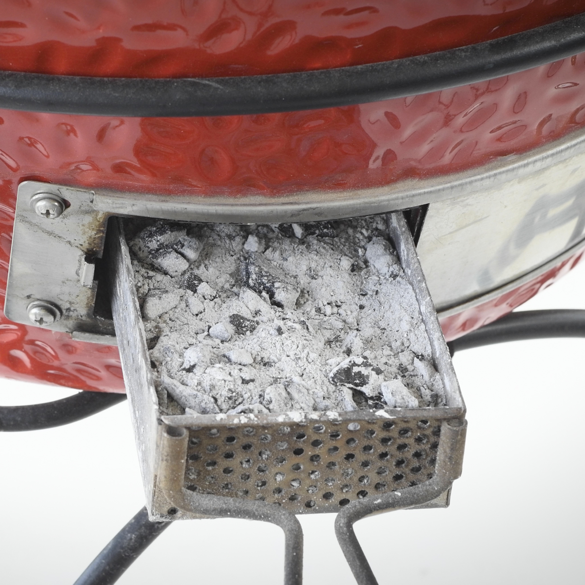 Kamado Joe ash drawer overflowing with ash.