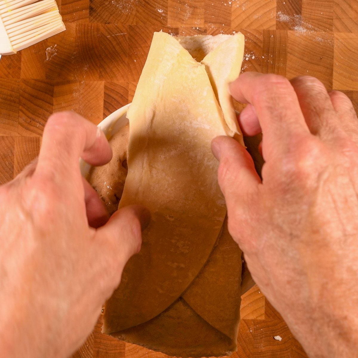 Lay puff pastry round over casserole dish.