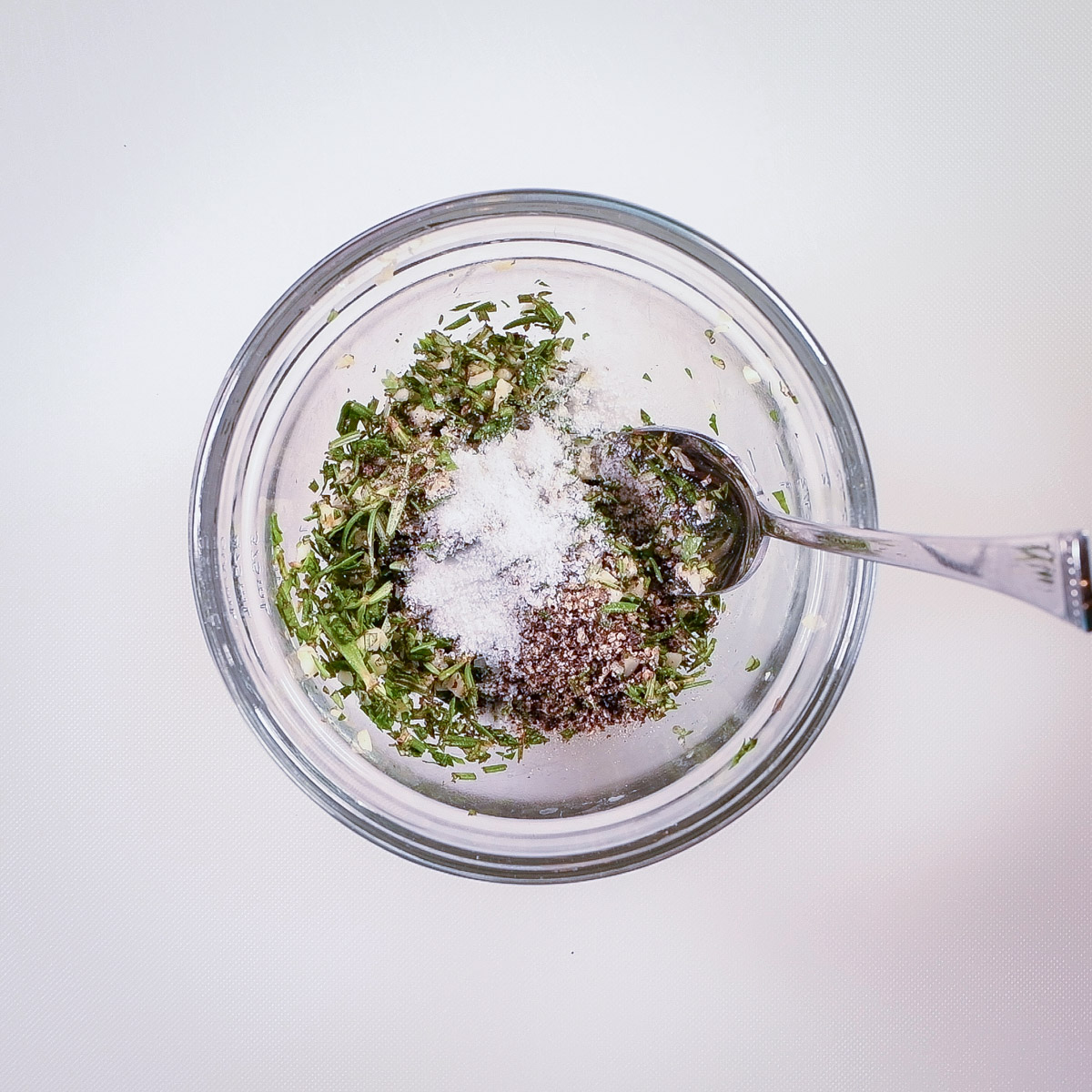 Mix the herbs and garlic with olive oil.