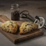 Chocolate-chip-scones on a wood board.