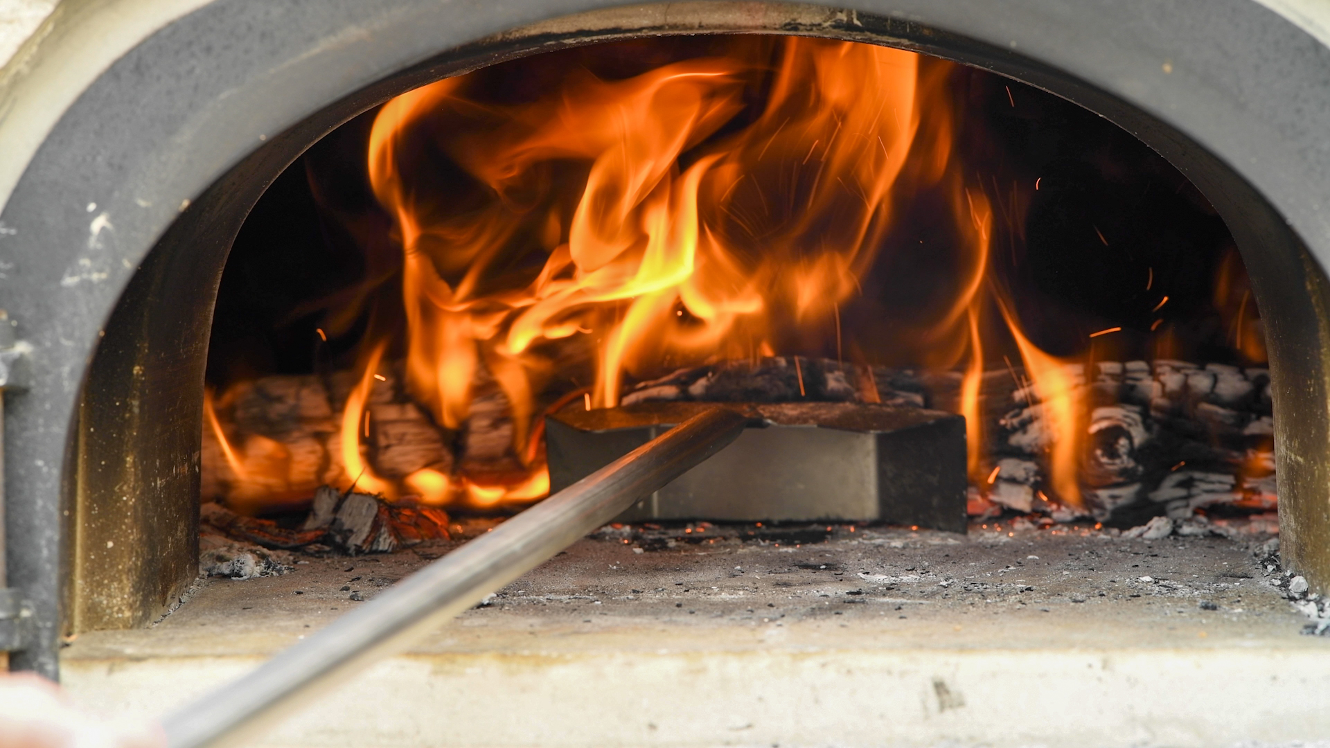 Using an Ember Rake to Push Hot Logs to the Back of the Oven.