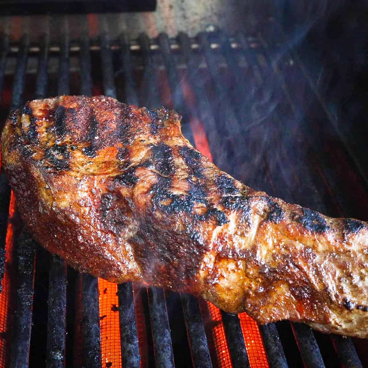 Sear the pork chops on a hot grill.
