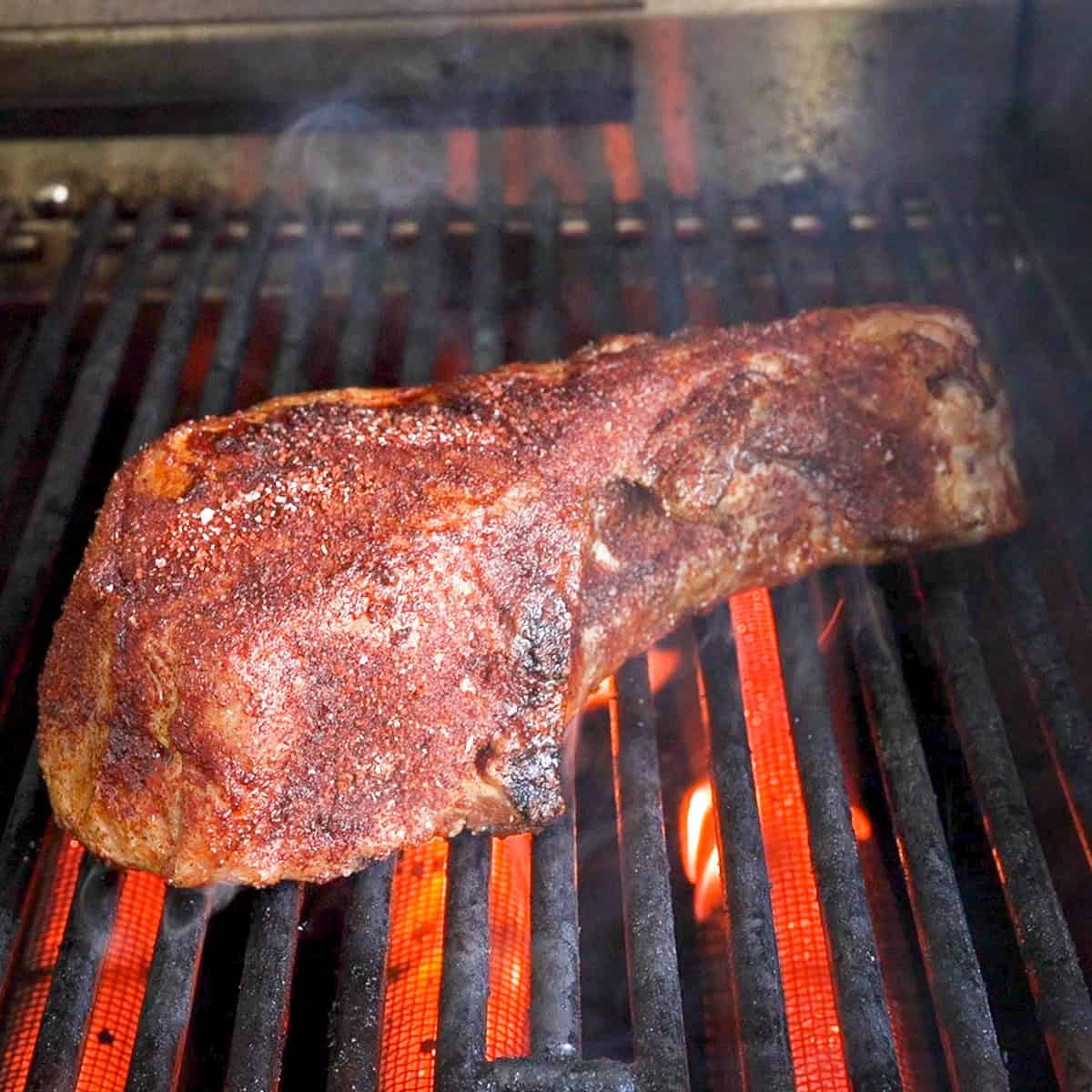 Sear the pork chops on a hot grill.