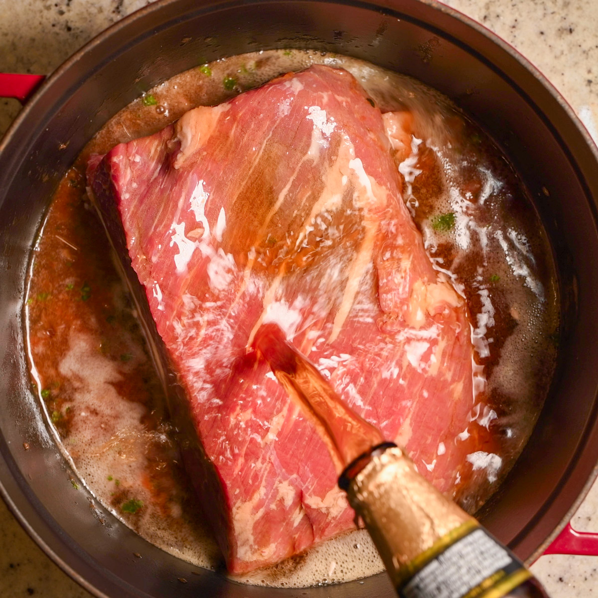 Pour beer over the brisket.