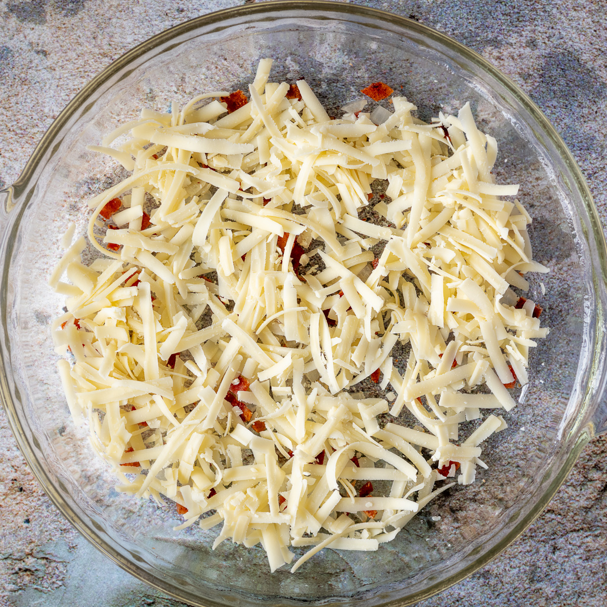 Add cheese on top of bacon and onion.