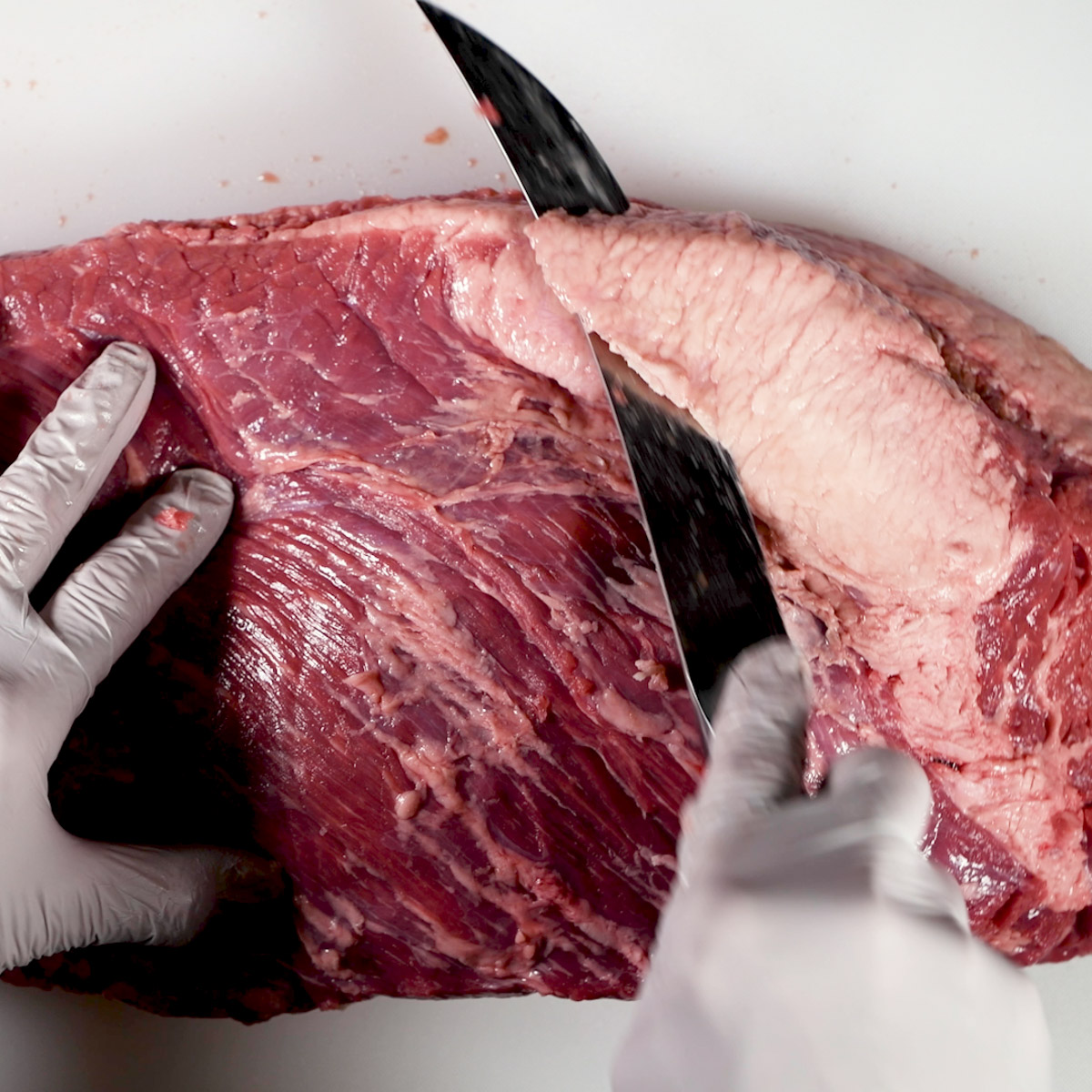 Trim the thick fat deposit on the meat side of the brisket..