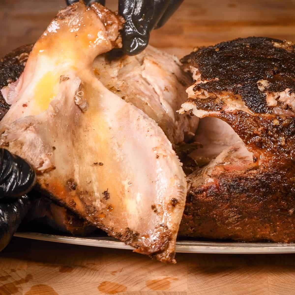 Carefully remove the bone from the pork shoulder.