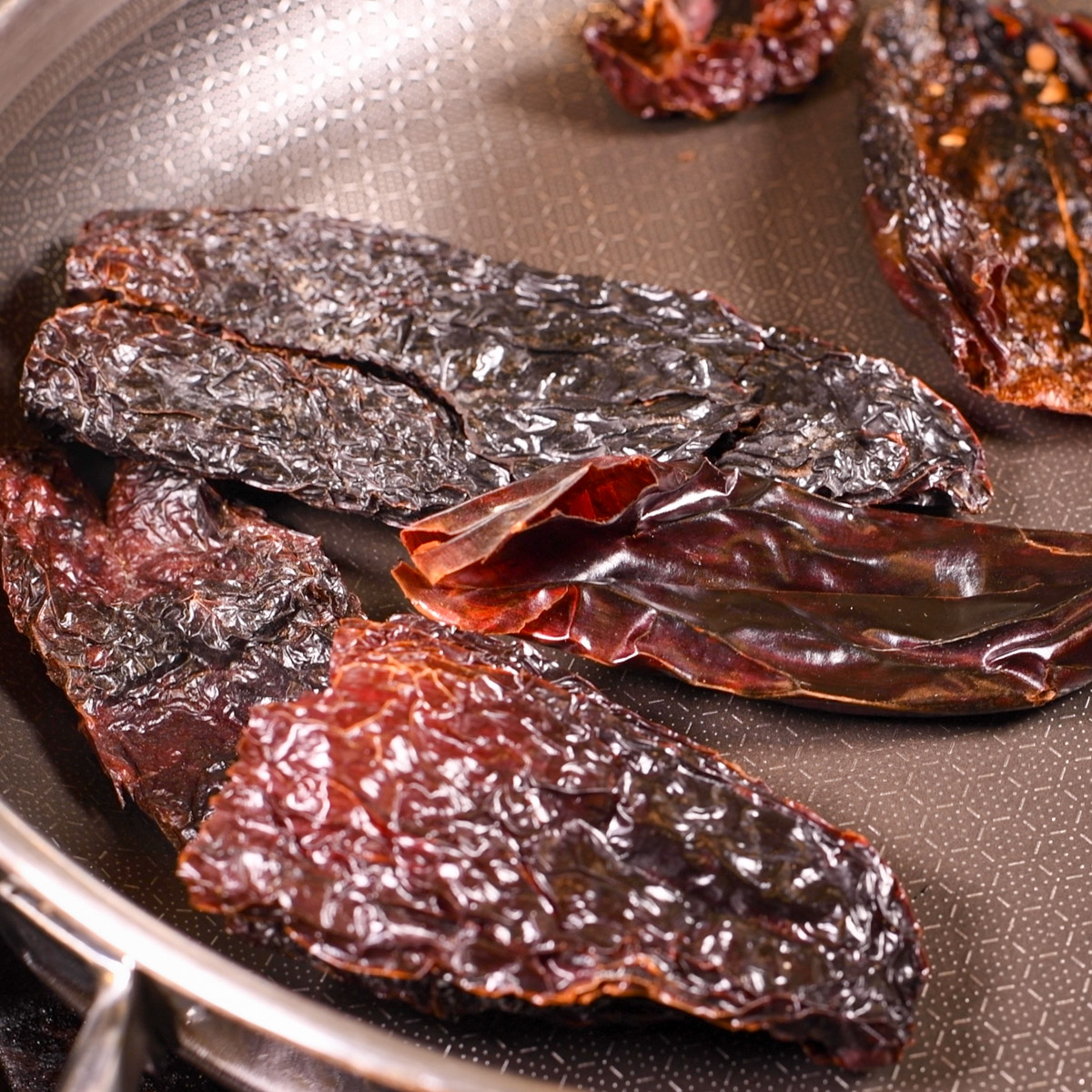 Toast the chiles in a hot skillet.