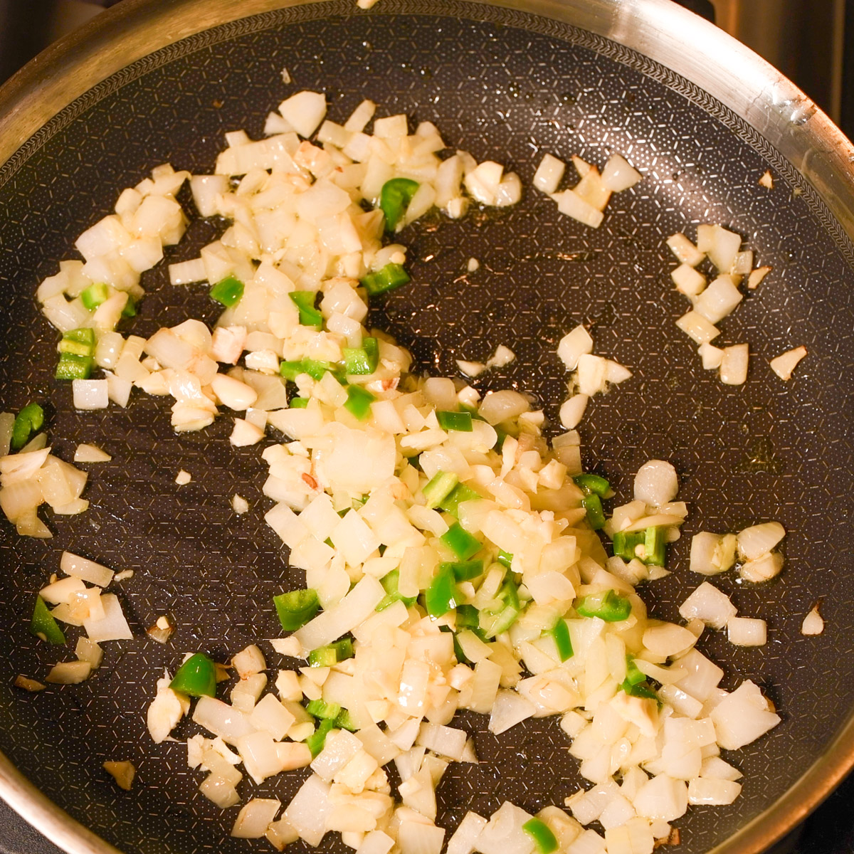 Saute onion, serrano pepper and garlic in olive oil.
