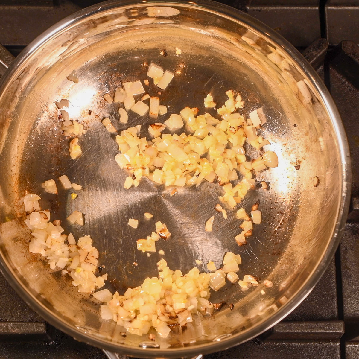 Sauté onion in garlic in a saucier pan.