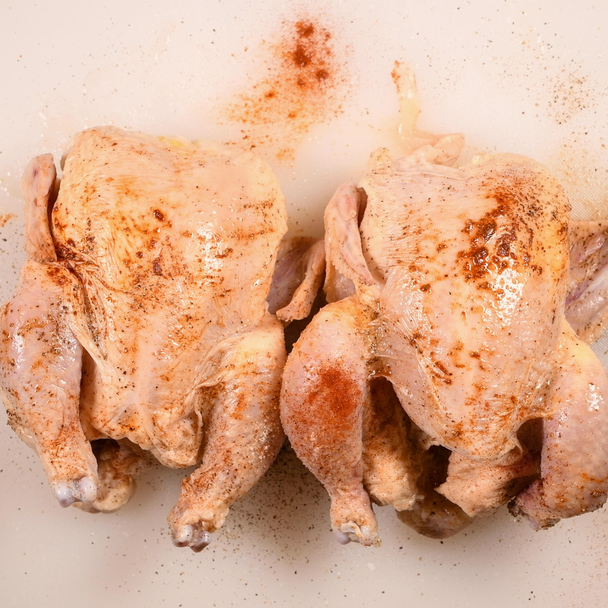 Season both sides of Cornish hens.