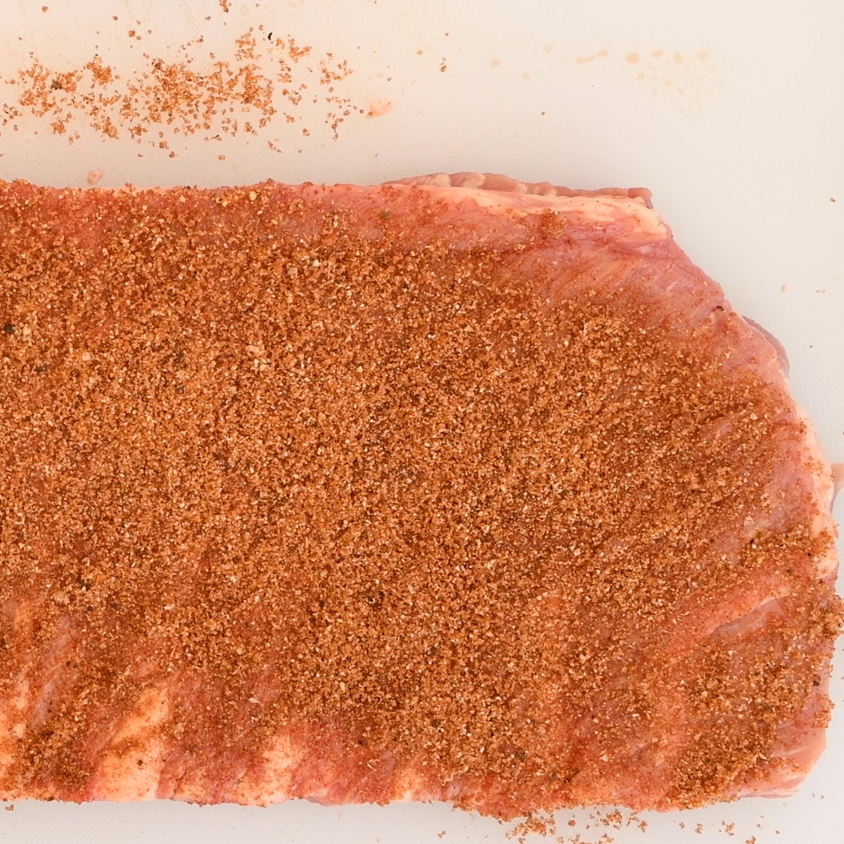 Season the ribs generously with a good dry rub.