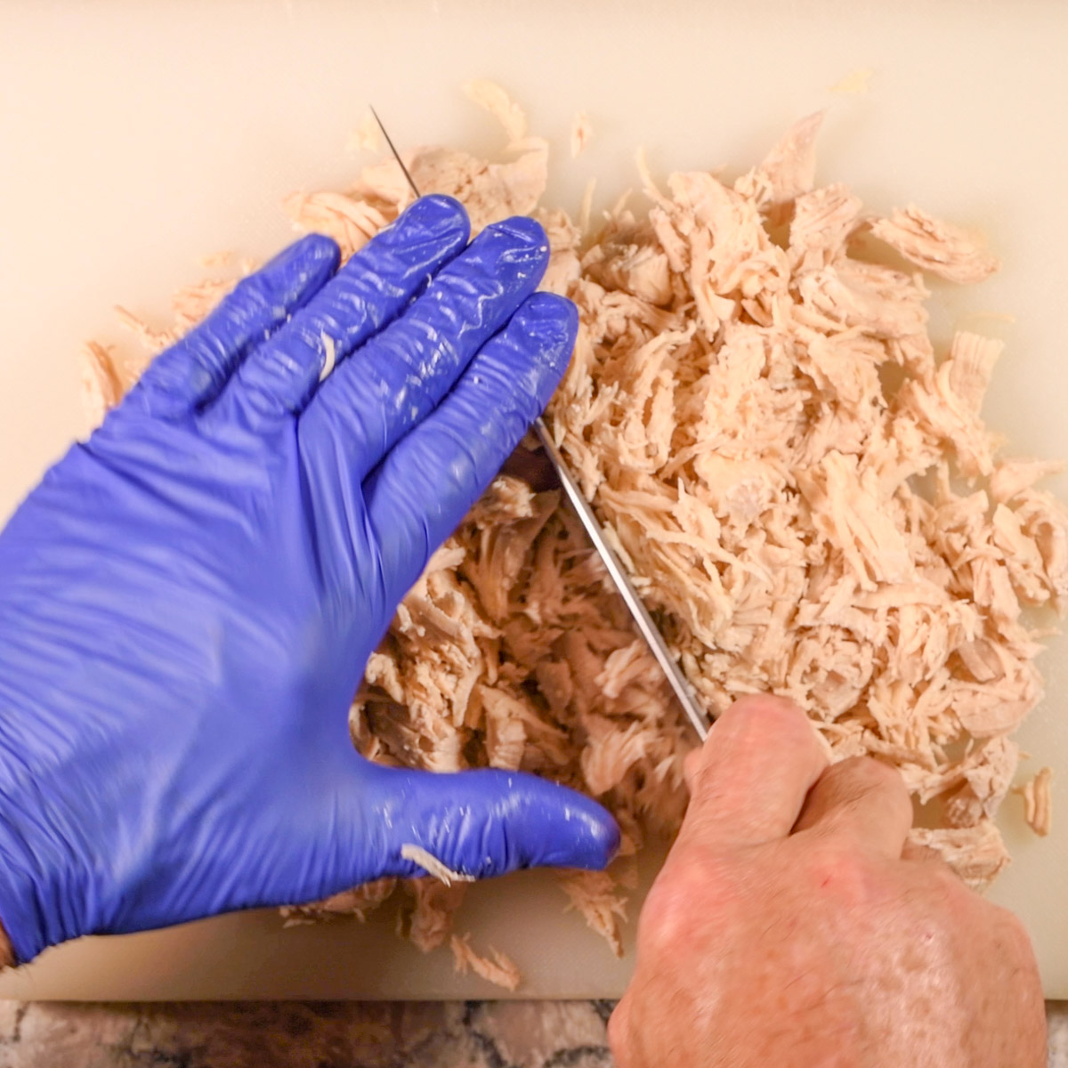 Shred or chop the cooked chicken.