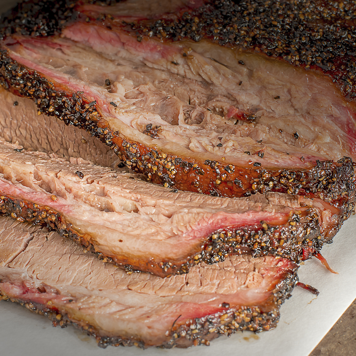 Sliced smoked brisket showing a tender flat