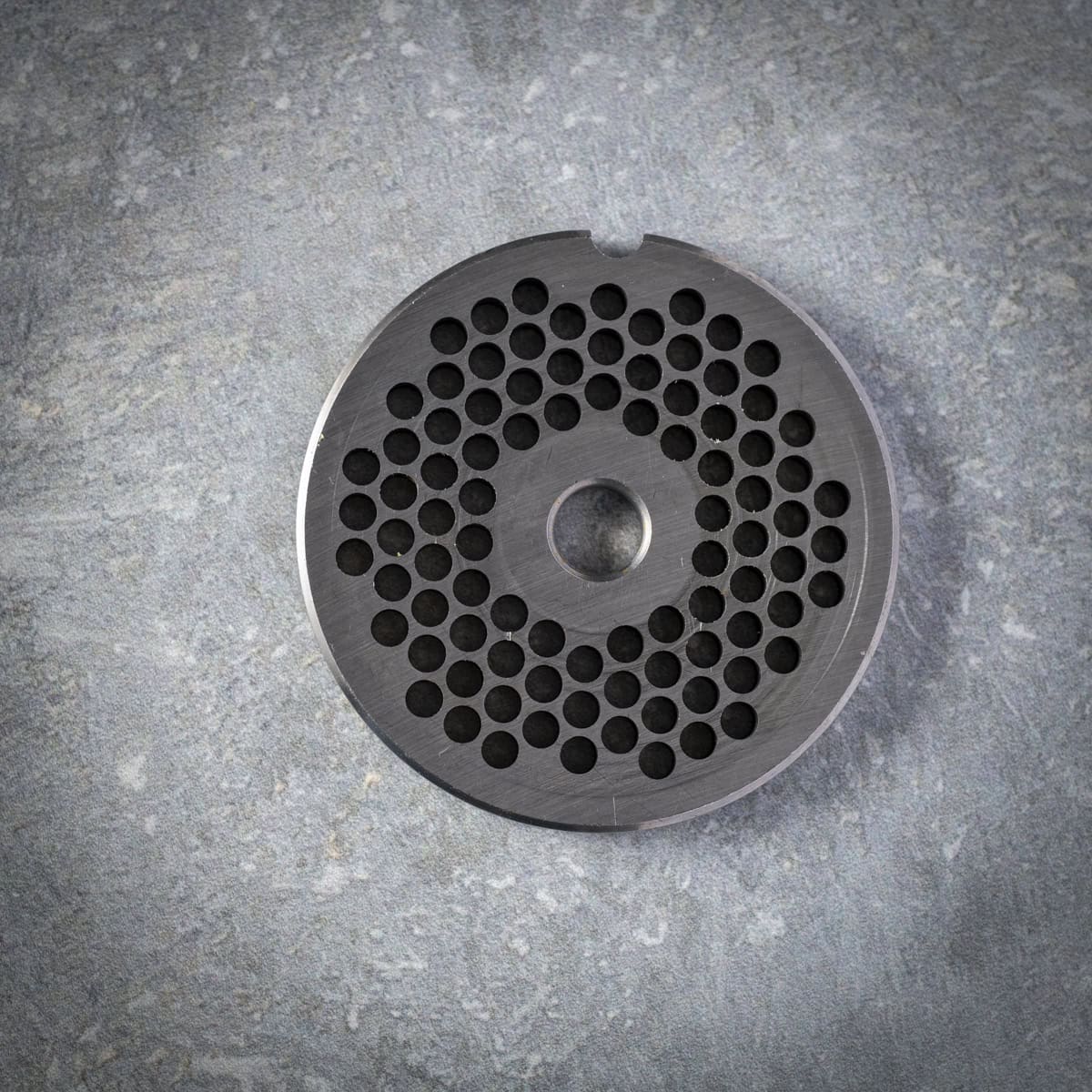 Small meat grinder plate.