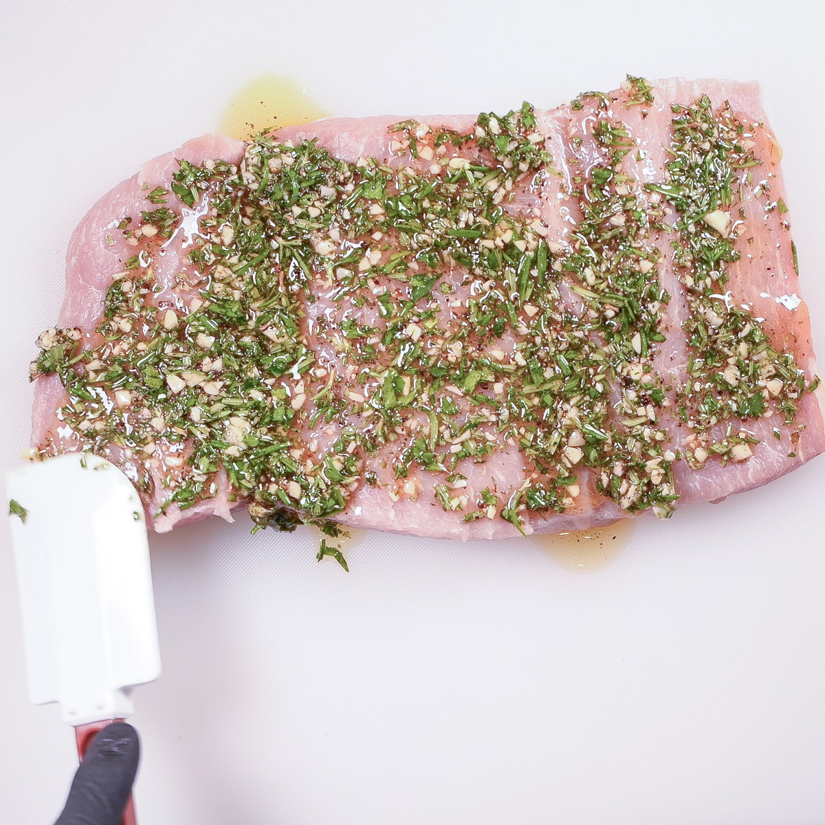 Use a spatula to spread the herb mixture.