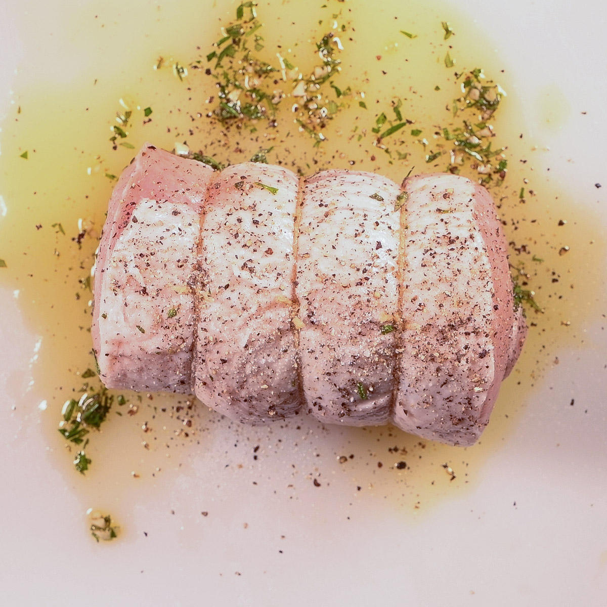 Tied pork loin with the fat side on top.