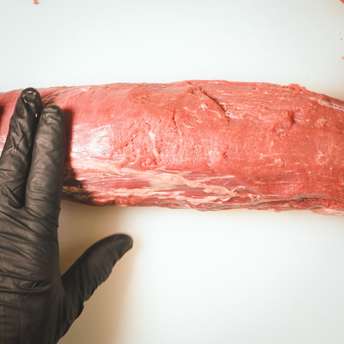 Trimmed beef tenderloin ready to cut.